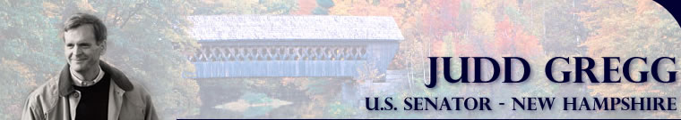 This is a header image which reads, "JUDD GREGG U.S. SENATOR - NEW HAMPSHIRE" over top of a faded covered bridge, valley, river, and foliage scene.  On the left hand side there is a black and white photo of Senator Judd Gregg in a sweater and jacket.