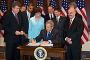 9-26-2006 - Senator Barack Obama and other members of Congress watch as George W. Bush signs S. 2590, the Federal Funding Accountability and Transparency Act of 2006, into law. The legislation will require the Office of Management and Budget to build a publicly accessible internet database of who receives federal money.