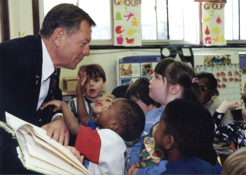 A picture of Senator Voinovich reading to school children