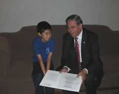 Senator Menendez meets with Dennis Zhang, winner of the US Forrest Service Poster Contest. July 13, 2006.style=