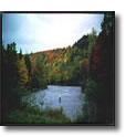 This is a photo of a scenic location on a river in Berlin, New Hampshire.  The river is winding through a valley with some classic New Hampshire foliage.