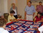 Tom watching and talking with volunteers of the Freedom Quilters