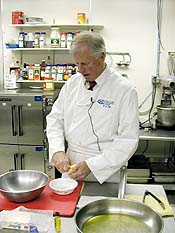 Photo of Congressman Mike Thompson in a kitchen teaching a cooking class.