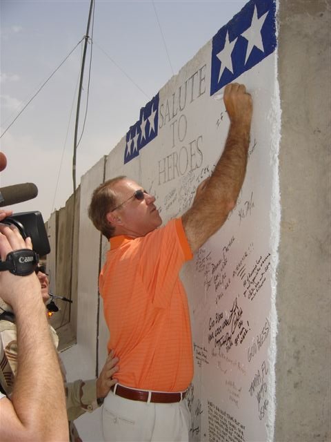 Steve Buyer, Chairman of the House Committee on Veterans' Affairs and Desert Storm veteran offers his thanks to troops of the 332nd Expeditionary Medical Group's theater hospital, on their Salute to Heroes wall, in Balad, Iraq, on August 17
