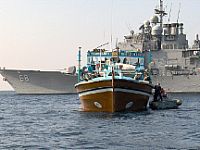 photo - Responding to a distress call, Sailors assigned to a rescue and assistance team from the U.S. Navy guided-missile cruiser USS Anzio (CG 68), provide aid to the motor vessel SINAA, a 35-meter Iranian-flagged dhow. 