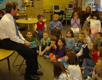 Brian reading to an elementary class.