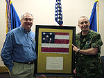 February 19, 2005 Colonel Garrett Harencak, commander of the 7th Bomb Wing at Dyess Air Force Base, and Congressman Neugebauer display a flag that was flown over the U.S. Capitol. 