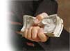 Close-up of a hand holding a bundle of money