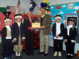 Congressman Barrett presents a flag to Principal Sharon Cagle of the 2006 Blue Ribbon School Aiken Elementary.
