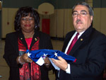 Butterfield presents a flag to Principal Moore at East End Elementary.