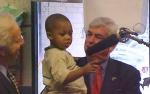 Senator Dodd and one of the children at the Navy Child Development Center