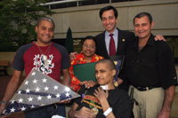 Congressman Luis G. Fortuo presents the Purple Heart Medal to PFC Emanuel Melendez Diaz, along with his father Julio Melendez, his mother Carmen Diaz and his brother Jesus Melendez Diaz.