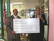 Congresswoman Carolyn Cheeks Kilpatrick presents a check for $99,200 to Randy McNeil, President of the Youth Sports and Recreation Commission. The Commission provides training and assistance to a variety of organizations and volunteers to enhance the quality and quantity of after-school programs for youth. 
