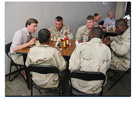 Congressman Rogers eats dinner with several soldiers from Alabama. The 
	soldiers were from the Army's 1st Armored Division.