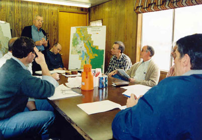 Denny is meeting with a group of timber industry officials in Columbia Falls.