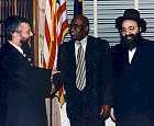 Congressman Towns greets Rabbi Niedermeyer.