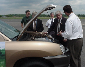 Photo of Congressman Larson looking at a fuel cell powered SUV