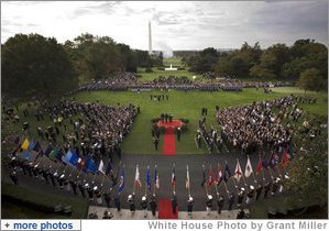 President George W. Bush and Prime Minister Silvio Berlusconi of Italy, seen from the Truman Balcony of the White House, stand together during the playing of the National Anthems at the South Lawn Arrival Ceremony of Prime Minister Silvio Berlusconi of Italy Monday, Oct. 13, 2008, at the White House.  White House photo by Grant Miller