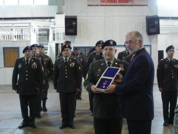 Congressman Bishop presents Staff Sergeant Louis Mazzarella with the Bronze Star, as members of his current unit, the 133rd Quartermaster Supply Company, look on.