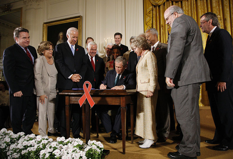President George W. Bush is joined by legislators and invited guests on stage Wednesday, July 30, 2008 in the East Room of the White House, during the signing of H.R. 5501, the Tom Lantos and Henry J. Hyde United States Global Leadership Against HIV/AIDS, Tuberculosis and Malaria Reauthorization Act of 2008