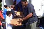 Congressman Meek and his son, Kendrick Jr., help deliver food to homebound seniors in Miami-Dade County.