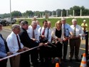 Officials line up for the ribbon cutting to mark the opening of the Hughesville Bypass. 