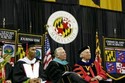 Hoyer looks on with President Mote and the student speaker, Ryan Cooper