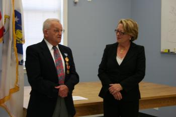Harvard resident and veteran Roland Martineau receives three service medals and two pins he earned for his service during War II.
