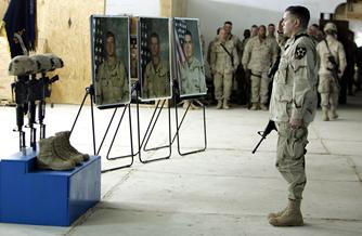Then-Col. Gary Patton salutes during a service for Staff Sgt. Thomas Vitagliano, Pfc. George Geer and Pfc. Jesus Fonseca. The men died Jan. 17, 2005, in Ramadi.