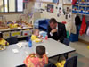 Congressman Rob Andrews meets with a child during lunch at Clementon Kindercare Learning Center in Clementon.  Congressman Andrews highlighted the importance of the federal school lunch program.