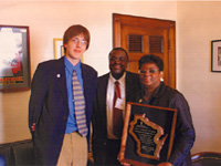  Representative Gwen Moore is presented with the YMCA Milwaukee Chapter Award for Outstanding Service by Julius Agara and Jared Peters
