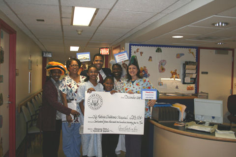 Congressman Jackson with staff from La Rabida Children's Hospital, displaying a check to the hospital for $215,174