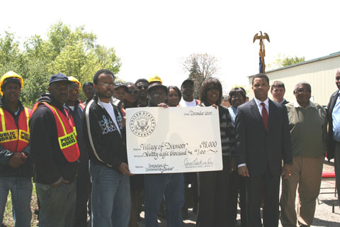 Congressman Jackson and representatives of the Village of Dixmoor holding giant check for $98,000 for 'Completion of Community Center'