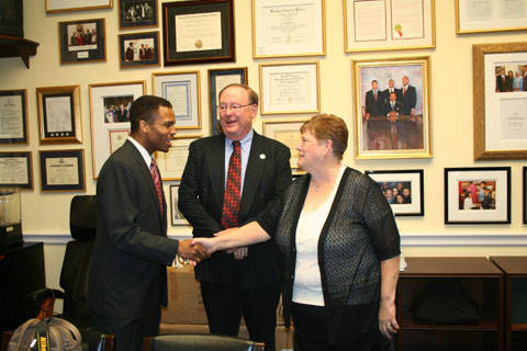 Congressman Jackson shaking hands with Cynthia Sedor; while Thomas Sedor looks on