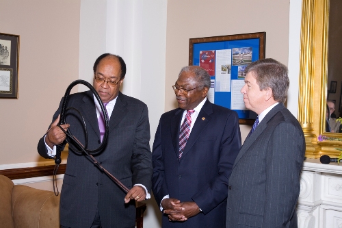 The first African American House Majority Whip, Former Rep. William Gray (D-PA), presenting Majority Whip Clyburn with a leather whip as a symbol of the work he will do in the 110th Congress to whip up support for the Democratic agenda. Joining them is Clyburn's counterpart, Republican Whip Roy Blunt of Missouri. The lawmakers plan to meet at regular bipartisan lunches to discuss ways they can work together for the American people