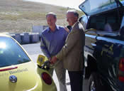 Senator Crapo and University of Idaho President Gary Lewis pump biofuel into a alternative energy vehicle.