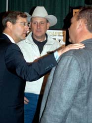 Senator Conrad meets with North Dakota residents Jeff Stewart (center) and Woody Barth at Marketplace 2004.