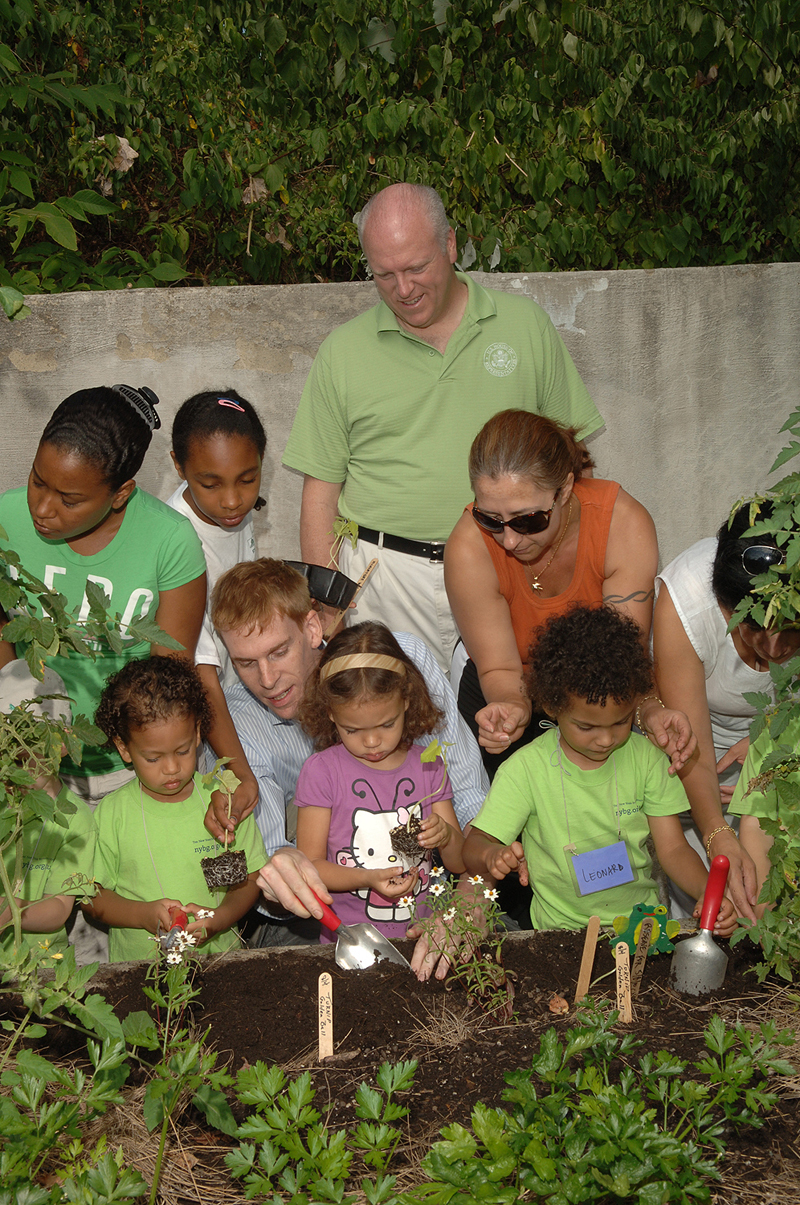 Congressman Crowley joins families from The New York Botanical Garden's Children's Gardening Program as they work in the garden