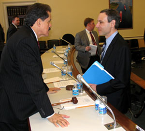 Serrano talking with Commissioner Shulman after the hearing