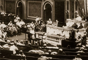 <a href="/member-profiles/profile.html?intID=202">Jeannette Rankin</a> of Montana, a suffragist and peace activist, and the first woman to serve in Congress, delivers her first full speech on the House Floor on August 7, 1917. Rankin addressed the need for federal intervention in copper mining during a period of unrest between labor unions and mining companies.