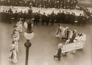 Suffragists parade in New York City in 1916 with a banner that reads &quot;President Wilson favors votes for women.&quot; Woodrow Wilson, a reluctant convert to the cause, eventually supported the 19th Amendment which passed the House in 1918 and was ratified by the states in 1920.