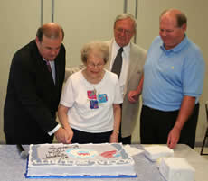 Congressman Costello and Joan Sackmann cut a cake for the 75th Anniversary of Social Security.