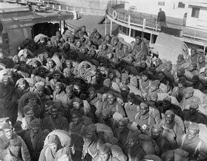 African-American troops of the 351st Field Artillery gather on the deck of the <em>U.S.S. Louisville</em> in February 1919 during their return voyage home from Europe.