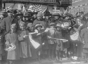 African-American families lined the streets of New York to celebrate the homecoming of the 369th Army infantry unit in 1919.