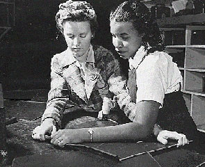 World War II brought women of all races out of the home and into the workplace. With millions of men serving overseas in the military, women filled many factory jobs. Above, two women worked together at the North American Aviation Company Plant.