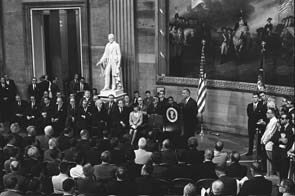 On August 6, 1965, President Lyndon B. Johnson signed the Voting Rights Act of 1965 in the Rotunda of the U.S. Capitol. The legislation suspended the use of literacy tests and voter disqualification devices for five years, authorized the use of federal examiners to supervise voter registration in states that used tests or in which less than half the voting-eligible residents registered or voted, directed the U.S. Attorney General to institute proceedings against use of poll taxes, and provided criminal penalties for violations of the act.