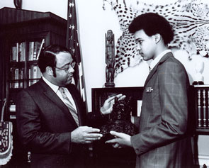 A leader behind the congressional movement to end apartheid in South Africa, <a href="/member-profiles/profile.html?intID=29">Charles Diggs, Jr.</a>, of Michigan was an authority on African-related issues. Representative Diggs and a House Page posed for this image in his office in the 1970s.
