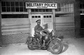 Nearly one million blacks served in World War II, most in the segregated U.S. Army. This 1942 picture of a military policeman astride his motorcycle on a base in Columbus, Georgia, underscored the reality that Jim Crow practices prevalent in civilian life were also a part of military service.
