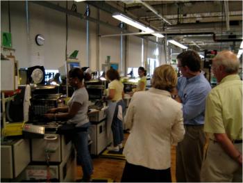 Tsongas learns from employees and company officials during a tour of the New Balance factory in Lawrence