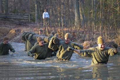 MARINE CORPS BASE QUANTICO, Va. - Marine Corps officer candidates training in 3rd Platoon, Company C, Officer Candidate Course 206, battle the waste-deep, bitter-cold water of Big Ford during the log drill race the morning of Dec. 2, 1010, at the Officer Candidates School aboard Marine Corps Base Quantico, Va. The race facilitated team-building and unit cohesion, something the candidates were no strangers to as they